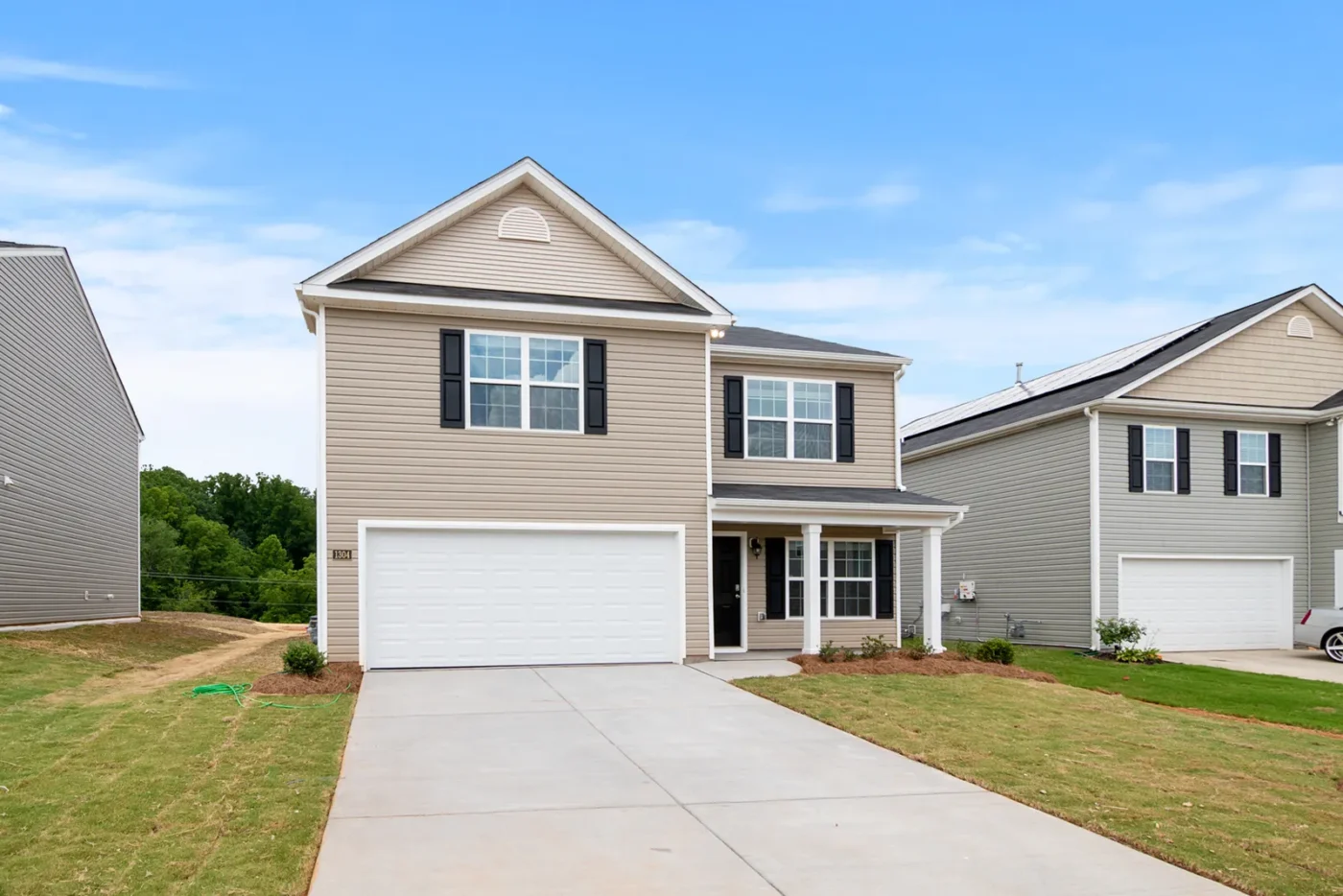 Newly built two-story home with a fresh lawn